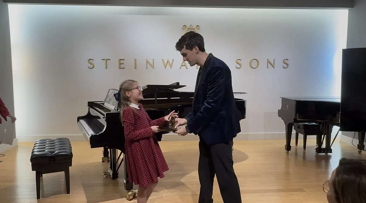 Student receiving her award at the Steinway & Sons gallery