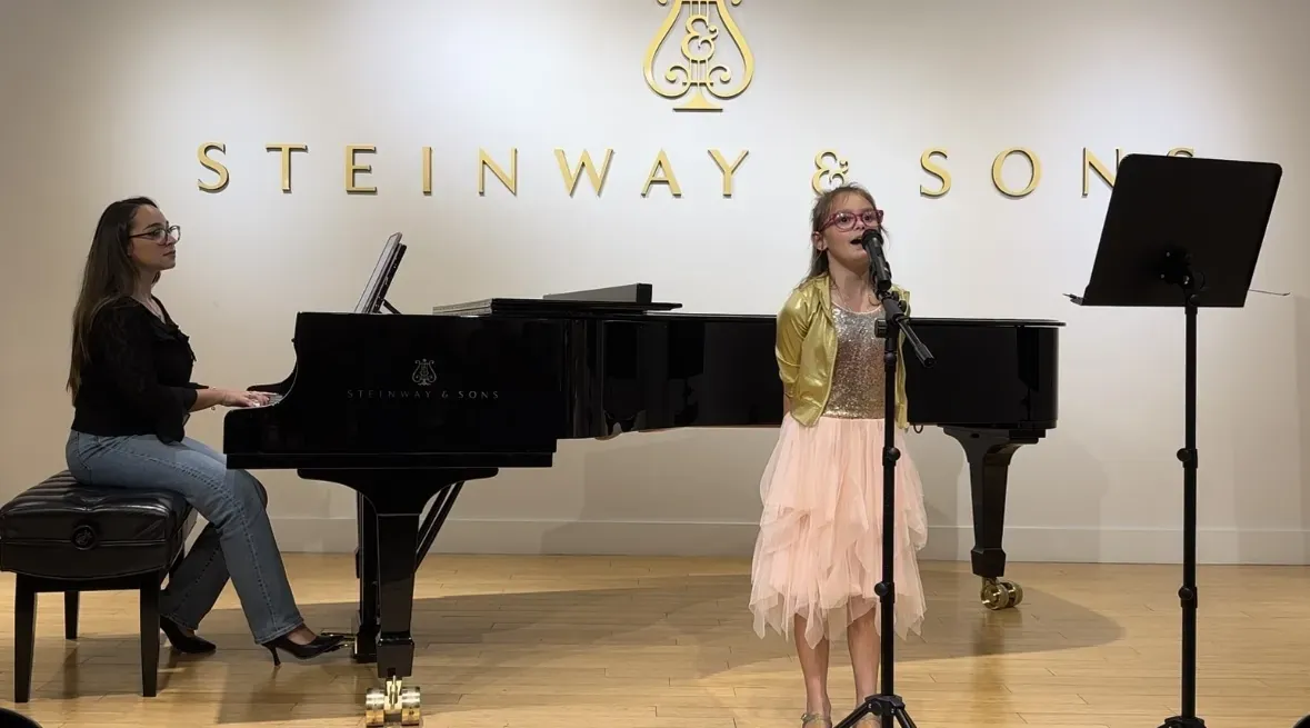 Student singing with piano accompaniment at Steinway & Sons