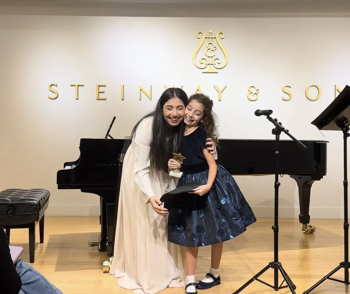 Teacher congratulating a student after her performance